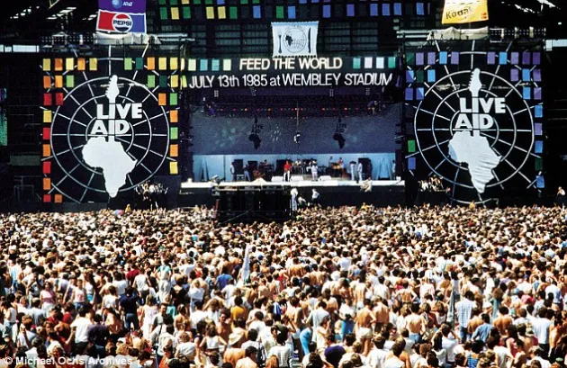 A photo of the crowd and stage at Live Aid Wembley Stadium in 1985.